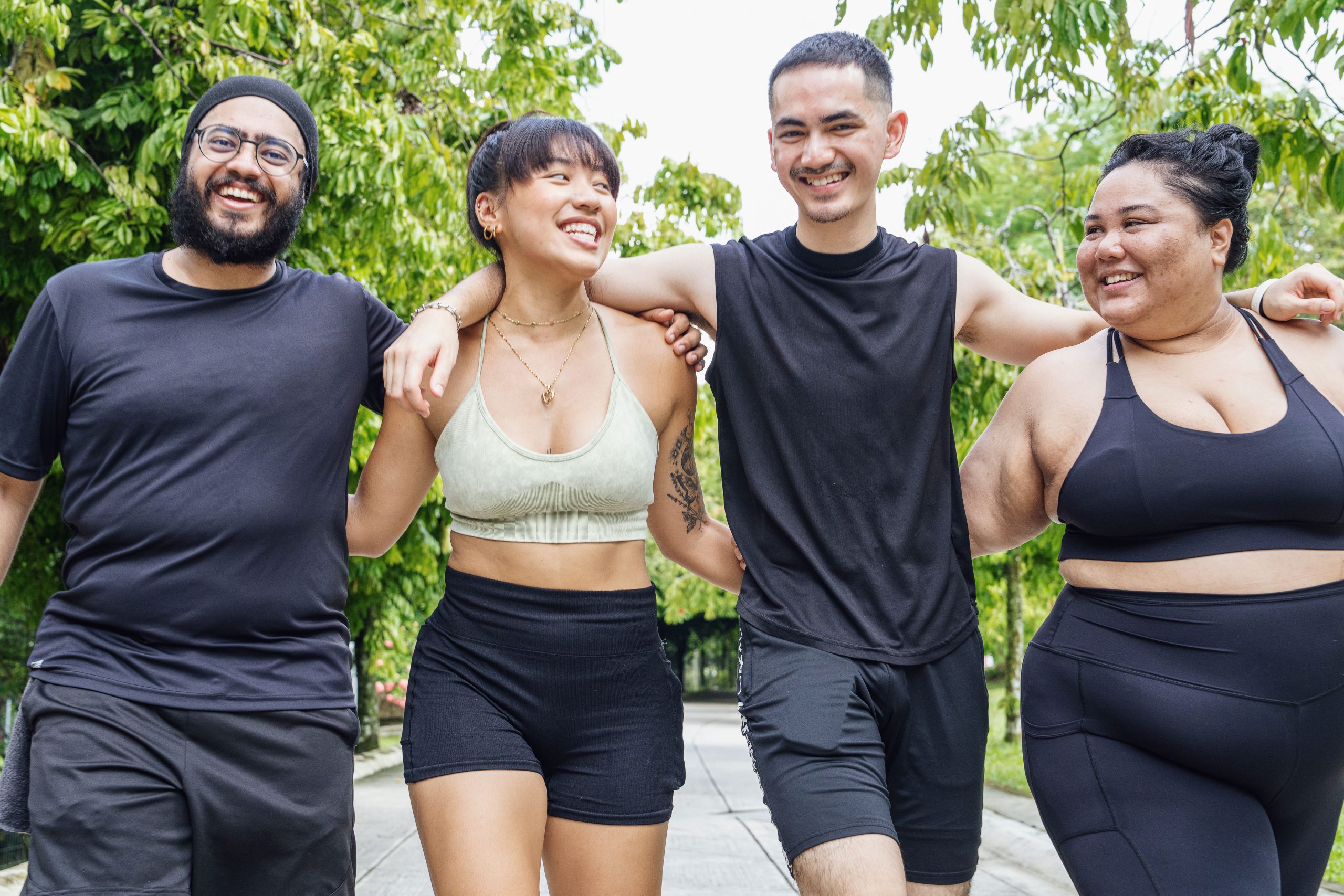 Group of friends walking together in the park, hugging